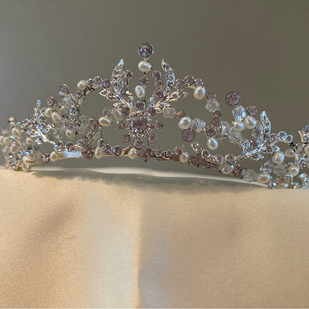 Tiara displaying Pearl and rhinestones against silver